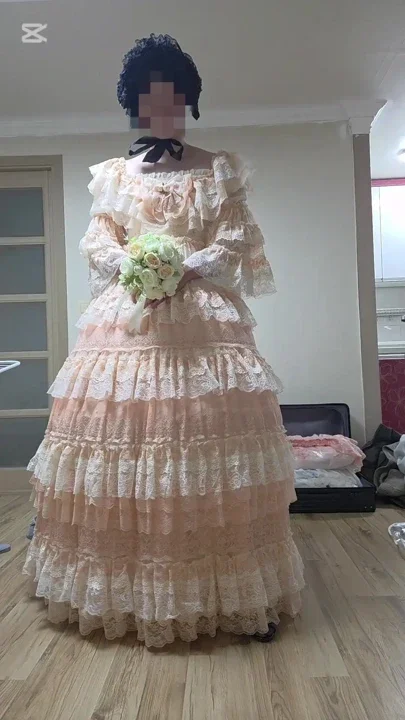 A man dressed as a woman dances in a dress