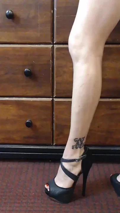 Oiled calves flexing high heels