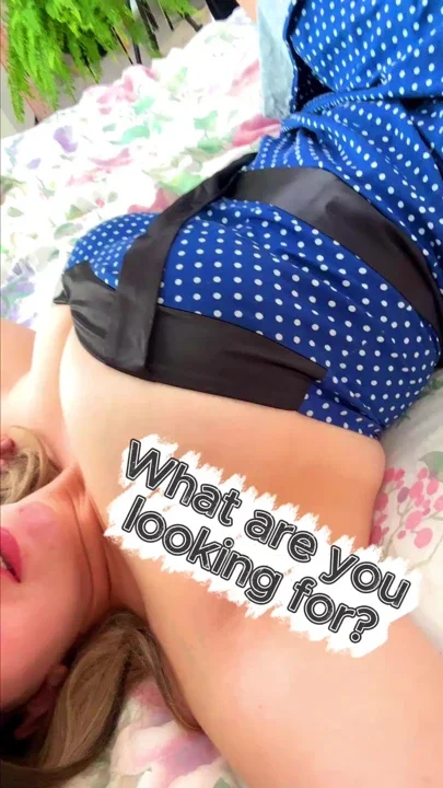 lying on the bed and wants to put on a dress