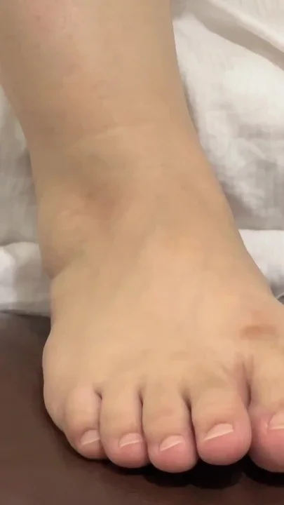Pretty Girl Grooming Her Cute Feet with Fresh Nail Polish