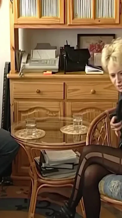 Skinny girl strips while having a conversation with a guy
