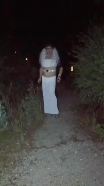 mature crossdresser in high heels smoke in the park
