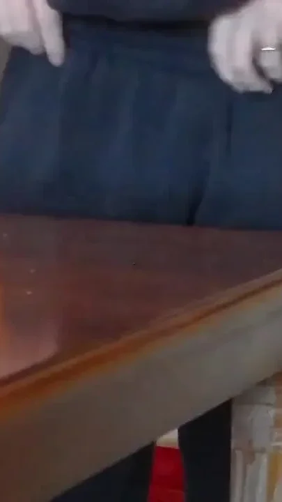 John is pissing on the dining table