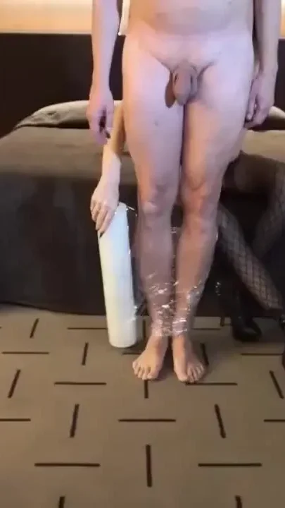 Femdom girl puts her slave in tape bondage