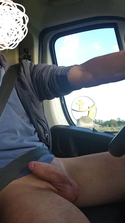 The handyman jerks off his big cock in the car while he is on his way to the