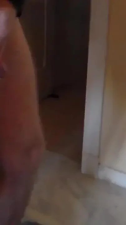 John is pissing on the floor in the livingroom