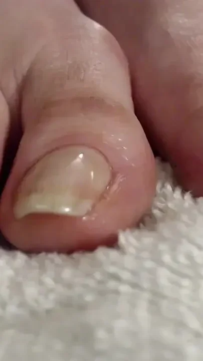 Long natural toenails oiled feet