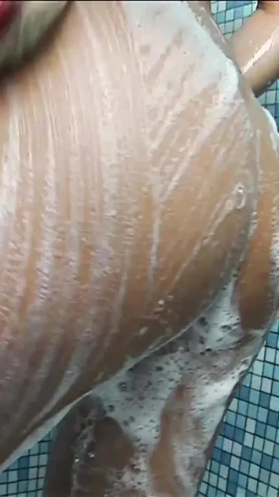 Teen playing with her purple toy in the shower