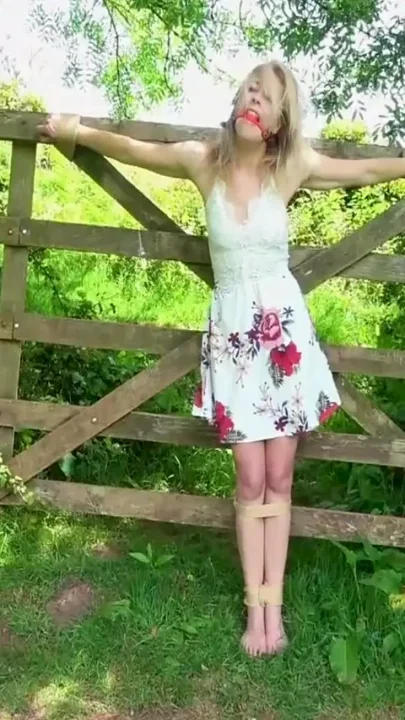 Damsel Tied to Gate Crucifix Bondage & Ballgagged