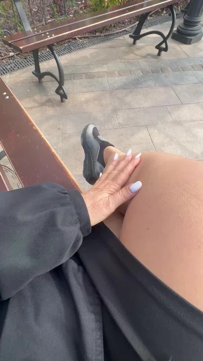 Hot stepmom shows her sexy legs on a bench in public