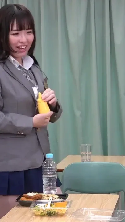 Japanese girl in a miniskirt uniform spits on a masochist's lunch box and plays