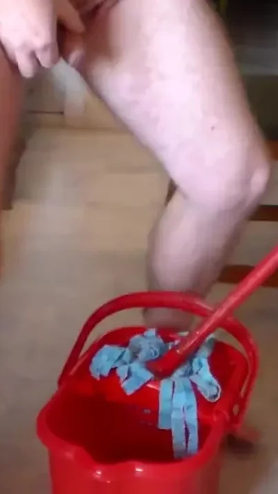 John is peeing into the cleaning bucket