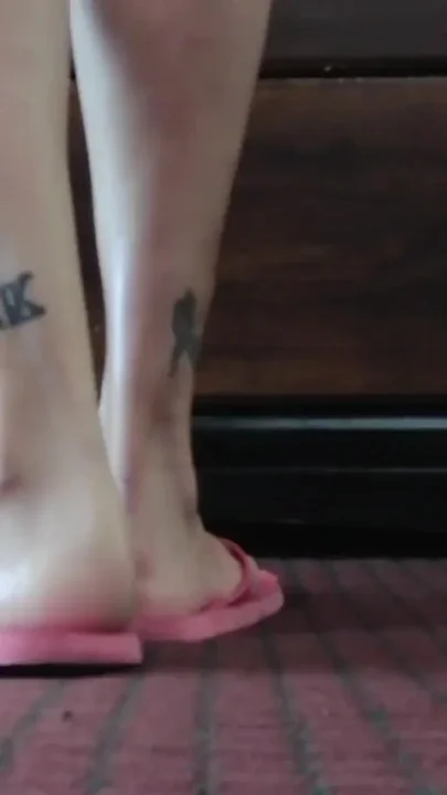 Worn out dirty pink flip flops