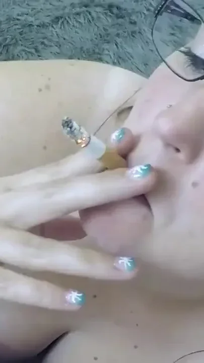 She smokes while sucking
