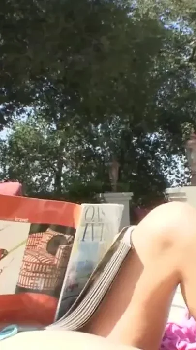Sunbathing brunette gets fucked at the swimming pool