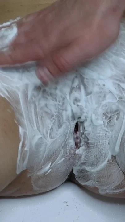 Shaving a hairy pussy with a large hole close-up Clip 2