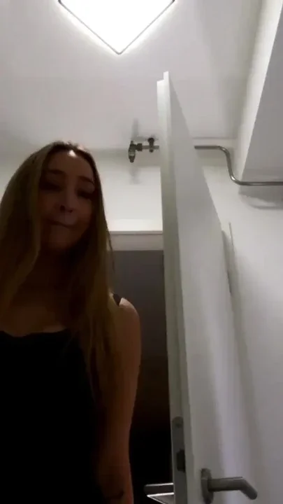 Amazingly beautiful college girl in the bathroom with a super skirt miniskirt