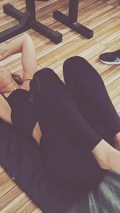 Gym Instructor Teaches Girl How to Warm Up
