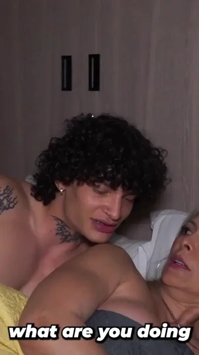 Busty Blonde Stepmother Ends Up Sharing Hotel Bed with Her Tattooed Stepson Clip 1