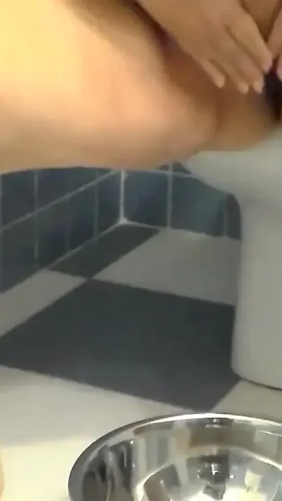 Jen is peeing into a steel bowl
