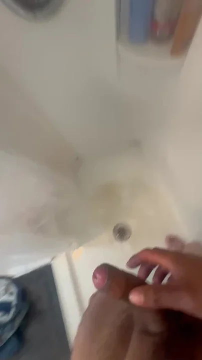 Latino in shower playing