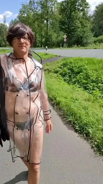 Walk in a transparent coat on the street Clip 1
