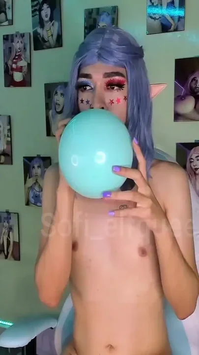 Young girl blowing and playing with balloons