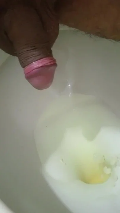 In the bathroom pissing