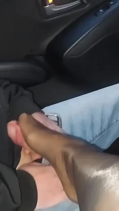Mature stepmom gives her stepson a nylon footjob in the car in public Clip 1