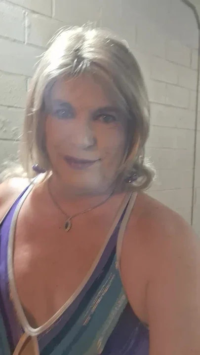 At the car wash getting wet in bathing suit and shorts