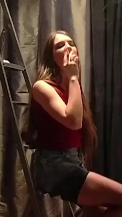 Busty girl in stockings smoking