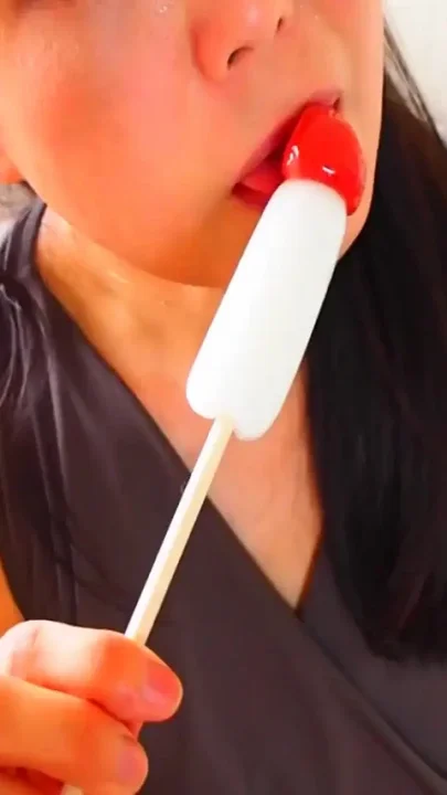Horny Asian MILF sucking on candy dick
