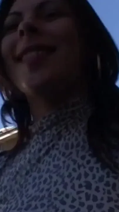 A real slut shows off her round ass on the street