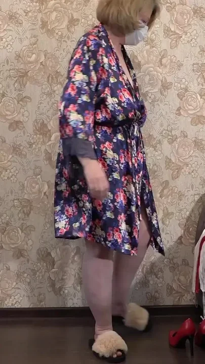 A Mature Wife Is Getting Ready for a Christmas Party and Trying on a Nurse's