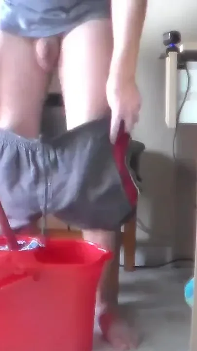 John is peeing all into the cleaning bucket