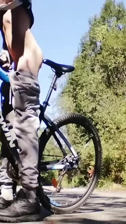 Slim boy with his bike in the park
