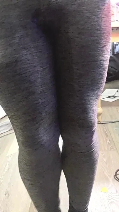 Gray leggings and sock puddle on vinyl floor