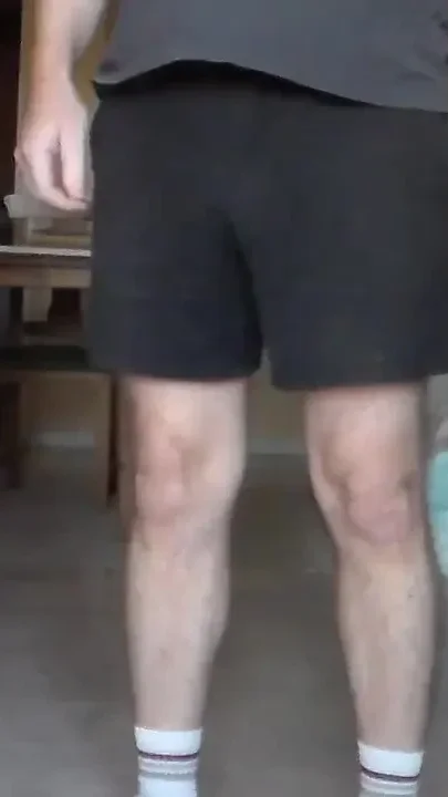 John is Peeing in his black shorts