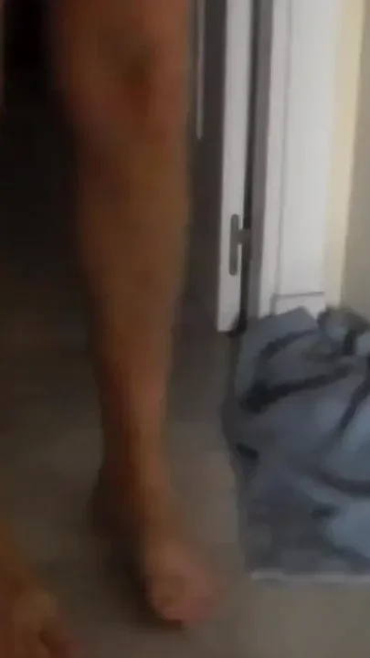 John is peeing on a towel in the hallway
