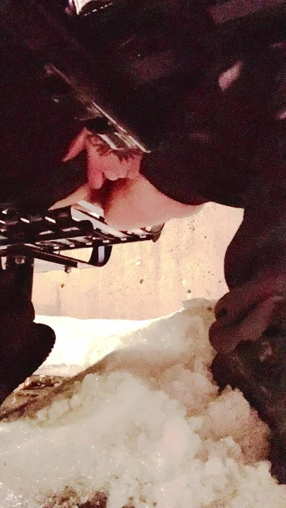 Pissing on snow sitting on a beach in public