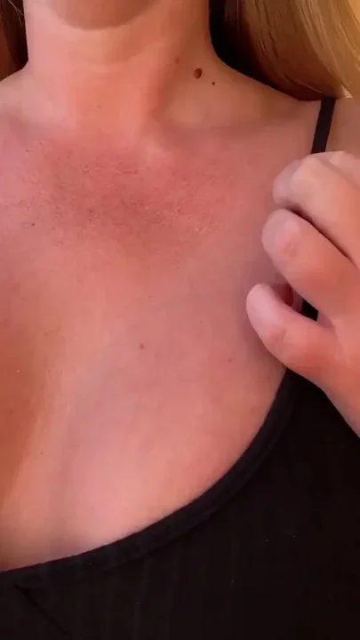 Teasing You with My Tanned Cleavage in a Black Dress