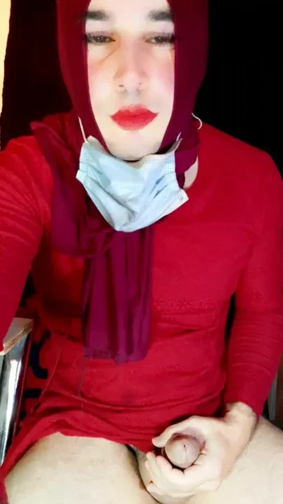 A sexy Indonesian trans woman wearing a hijab manually stimulates her penis and