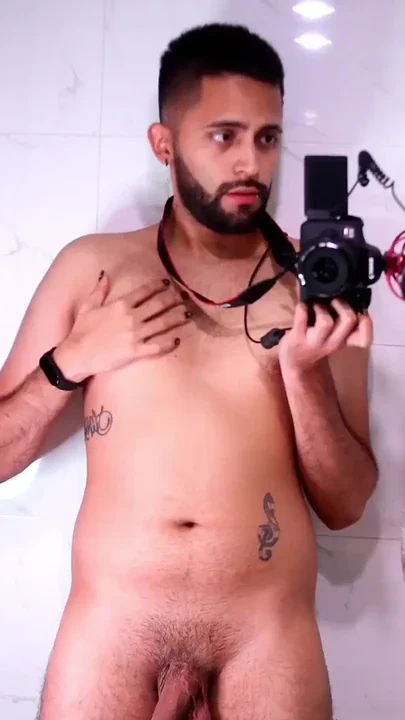 Horny latino stroking his big uncut dick in the mirror until he cums