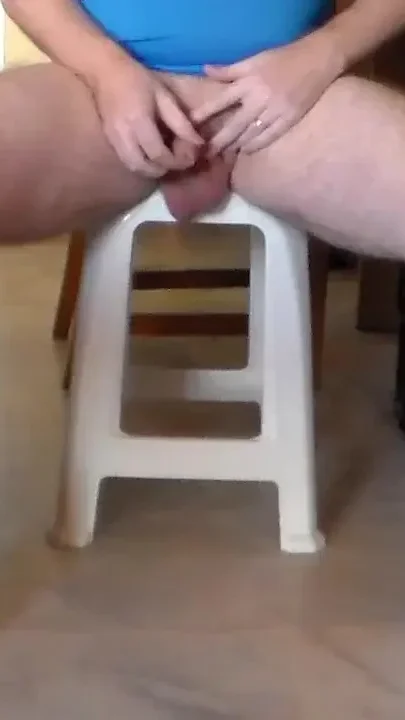 John is sitting on a chair a peeing all over the floor