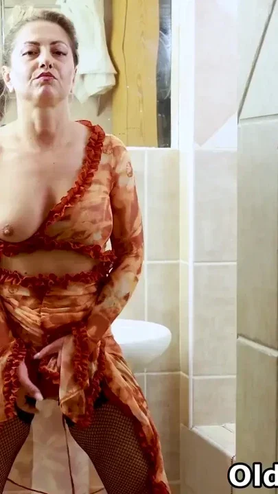 Euro milf Jane Sweet wears black fishnet stockings and relaxes in the bathroom Clip 2