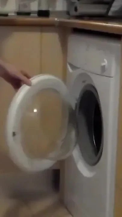 John is peeing all into the washing machine