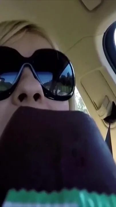 First hands on the steering wheel then mouth on the cock