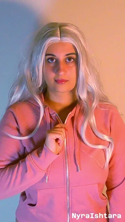 Busty blonde unzips her hoodie to tease her enormous chest in a pink bra