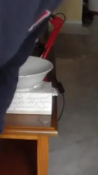 John is pissing in a bowl in closeup