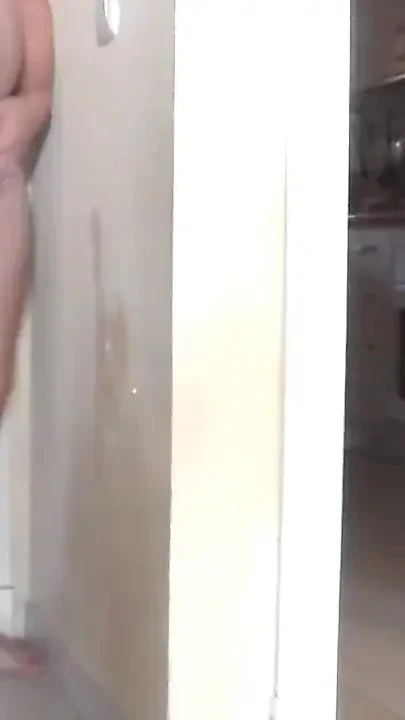 John is peeing it all on the wall in the hallway